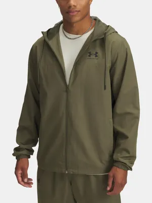 A man wearing an olive green Under Armour windbreaker jacket.