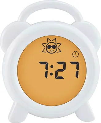 A white alarm clock with a digital display showing the time and a sun icon.