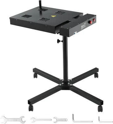A black screen printing dryer with an adjustable stand and wheels, shown against a white background. Several wrenches and Allen keys are displayed in the foreground.