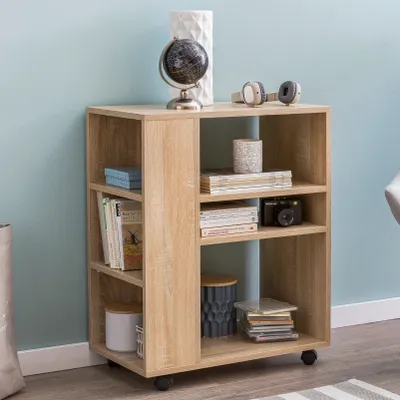 A wooden shelving unit with various items on its shelves, placed against a light blue wall.