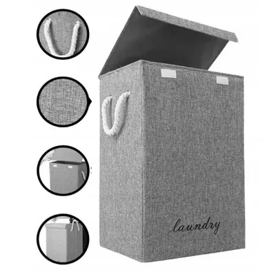 A grey laundry basket with a lid and rope handles is shown from the front.