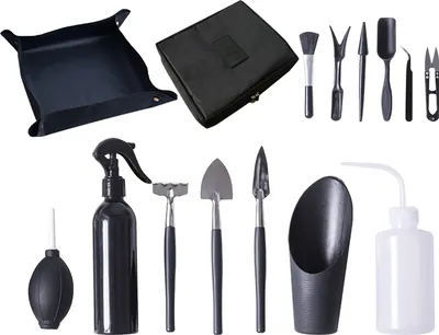 A collection of gardening tools for planting and care, including a tray, case, various hand tools, and spray bottles.