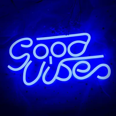 A blue neon sign that says "Good Vibes" against a dark blue background.