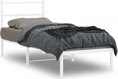 A white metal bed frame with bedding.