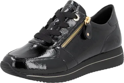 A black patent leather sneaker with a gold zipper.