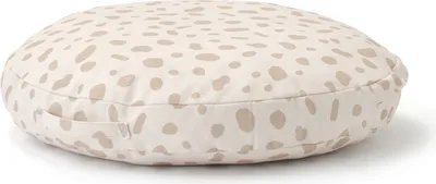 A round floor cushion with a speckled pattern.