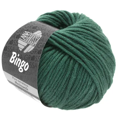 A ball of dark green yarn with a label wrapped around it.