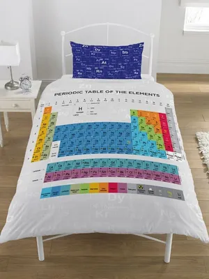 A duvet cover and pillowcase set featuring a periodic table design, displayed on a bed.