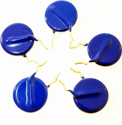 Five blue electronic components with gold leads arranged in a star shape on a white background.