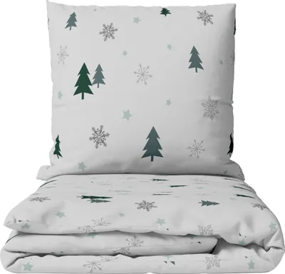 A stack of folded bedding with a winter-themed pattern.