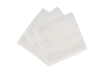 A stack of white gauze pads on a white background.