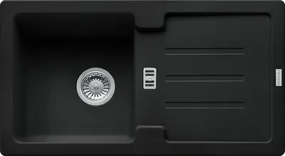 A top-down view of a black granite kitchen sink with a drainer.