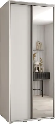 A white wardrobe with a mirrored door, reflecting a shelf with decorative items and a console table.