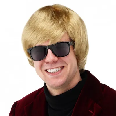 A man wearing a blond wig and sunglasses, with a red jacket and black turtleneck.