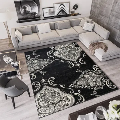 A modern living room with a sectional sofa, rug, and coffee table.