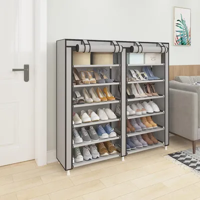 A shoe rack filled with shoes, placed next to a door.