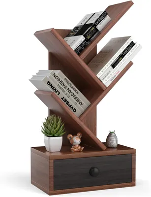 A wooden bookshelf with a tree-like design, featuring multiple shelves and a drawer at the bottom. It is decorated with a small potted plant, a figurine, and another decorative object.