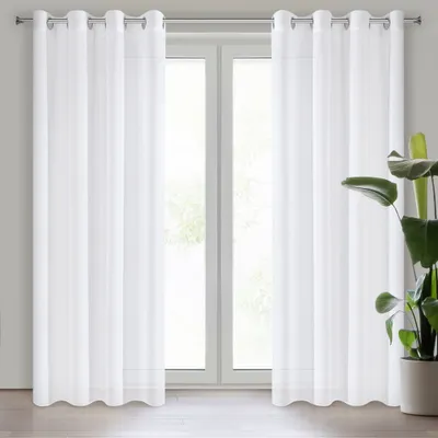 Two white sheer curtains hanging in front of a window.