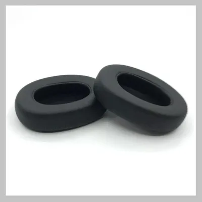 Two black ear pads for headphones are shown on a white and light gray background.