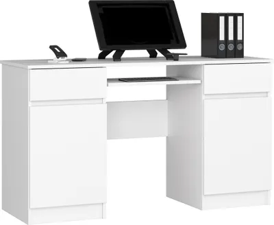 A white desk with a monitor, keyboard, and binders.