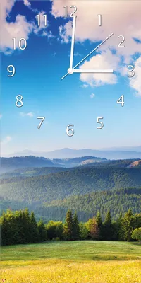 Produktbild von Wallario Design Wanduhr bedruckt, Größe 30 x 60 cm, Motiv: Berglandschaft im Gebirge unter blauem Himmel