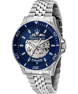A close-up studio shot of a men's automatic watch with a blue dial and silver metal band.