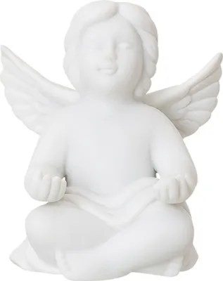A white ceramic angel figurine in a meditative pose.