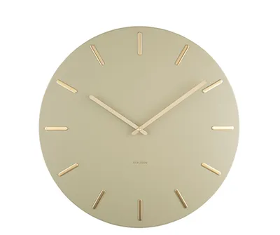 A round wall clock with gold hour markers and hands on a light green face.