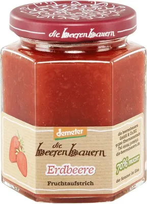 A jar of strawberry jam on a white background.