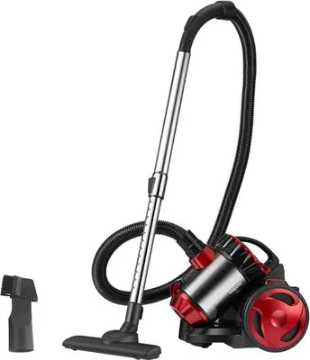 A studio shot of a red and black canister vacuum cleaner with its accessories.