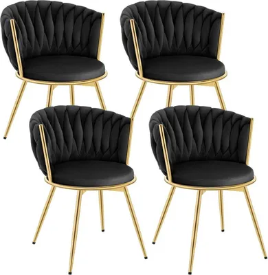 Four black velvet chairs with gold metal legs are arranged in a grid against a white background.