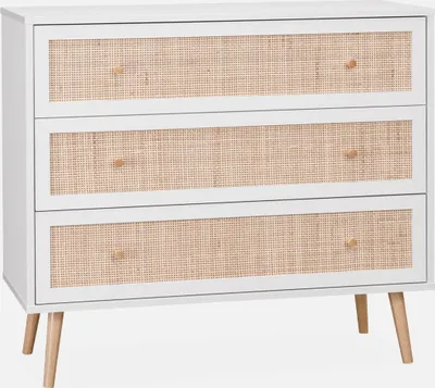 A white three-drawer dresser with rattan-woven drawer fronts and wooden legs, displayed against a white background.