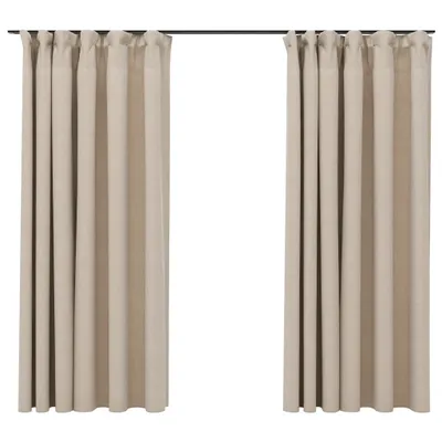 Two beige curtains hanging from a curtain rod against a white background.