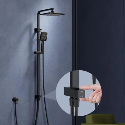 A black shower system is mounted on a blue wall, with a close-up inset showing a hand interacting with a control.