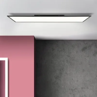 A modern LED ceiling light fixture mounted on a white ceiling, with a pink wall and a textured gray wall visible below.