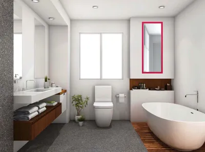 A modern bathroom with a freestanding bathtub, toilet, vanity, and a mirror with a pink frame.