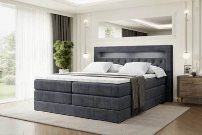 A bedroom scene with a large bed as the focal point.