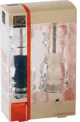 A set of Peugeot salt and pepper grinders in their original packaging.