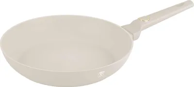 A beige frying pan with a gray handle is shown against a white background.
