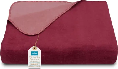 A folded blanket with a tag attached.