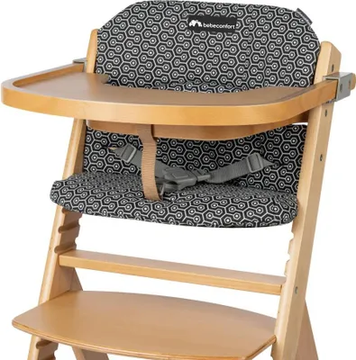 Close-up of a baby high chair with a patterned cushion and tray.