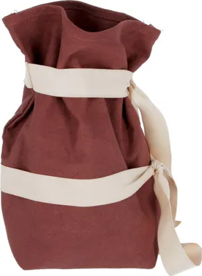 A brown fabric bag with beige straps tied around it.