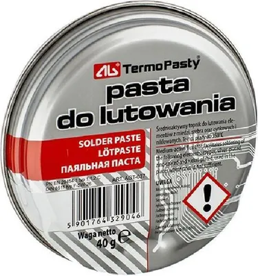 A top-down view of a round metal tin containing solder paste.