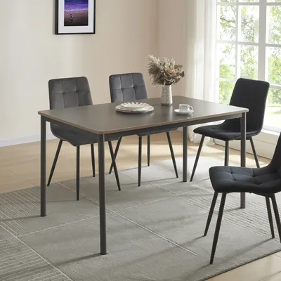 A dining table with four chairs in a room with a window and a painting on the wall.