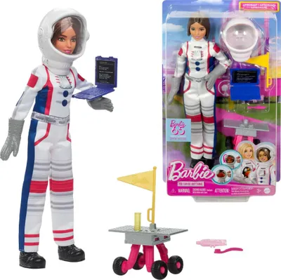 A Barbie astronaut doll and its packaging, along with accessories.