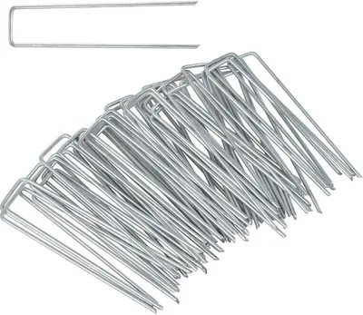 A pile of metal tent stakes on a white background.