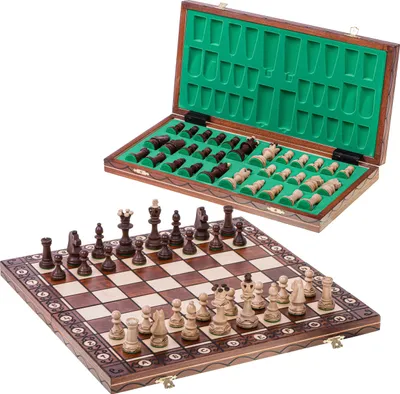 A wooden chess set with pieces stored in a case and a board set up.