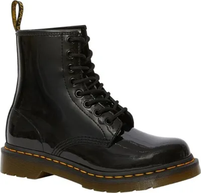 A black patent leather Dr. Martens boot is shown against a white background.