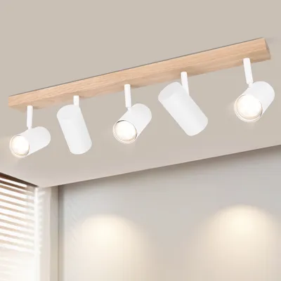 A ceiling light fixture with five adjustable spotlights mounted on a wooden beam, attached to a ceiling.