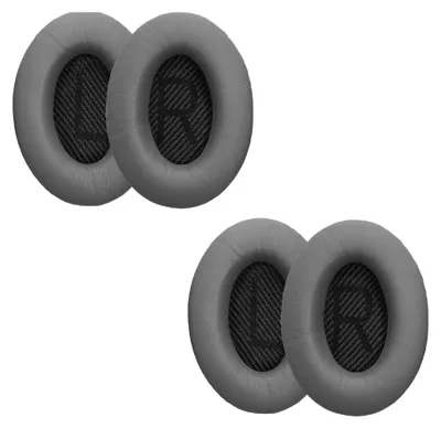 Four grey ear pads for headphones are arranged in two pairs on a white background.